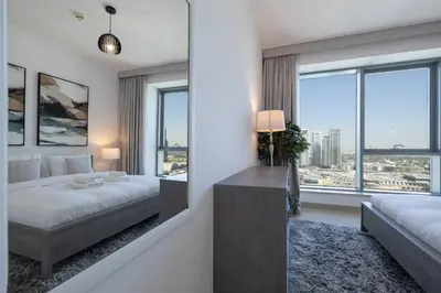 a bedroom with a bed and a large window at Signature 2BR with Burj Khalifa & Fountain View in Dubai