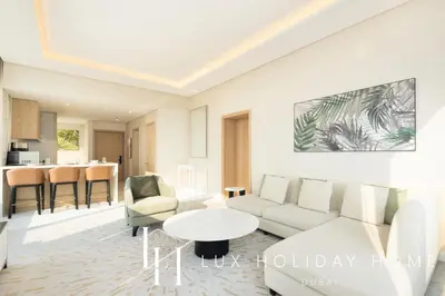 a living room with a couch and a table at LUX Iconic Views at The Palm Tower Suite 3 in Dubai