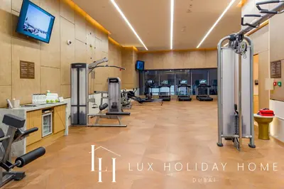 a gym with treadmills and machines in a room at LUX Iconic Views at The Palm Tower Suite 3 in Dubai