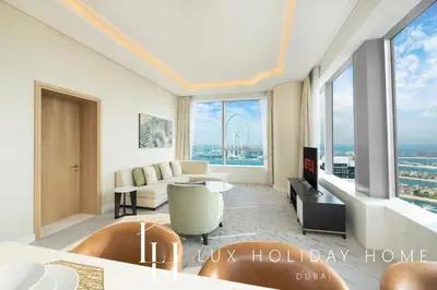 a living room with a couch and a table at LUX Iconic Views at The Palm Tower Suite 3 in Dubai