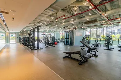 a gym with several treadmills and exercise machines at Luxury MAG 318 Studio Near Dubai Mall in Dubai