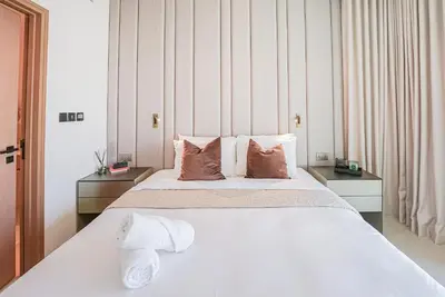a bedroom with a large white bed with pillows at Modern 2BR High Floor Haven in Vida Dubai Marina in Dubai