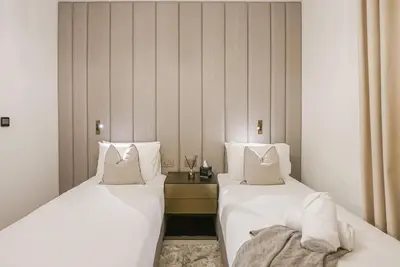 two beds sitting next to each other in a room at Modern 2BR High Floor Haven in Vida Dubai Marina in Dubai