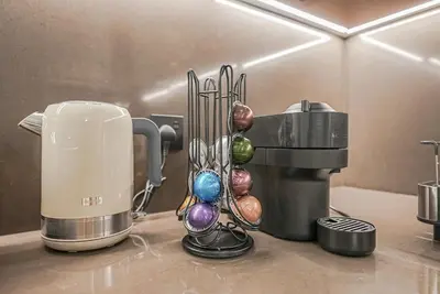 a kitchen counter with a coffee maker and a mixer at Modern 2BR High Floor Haven in Vida Dubai Marina in Dubai