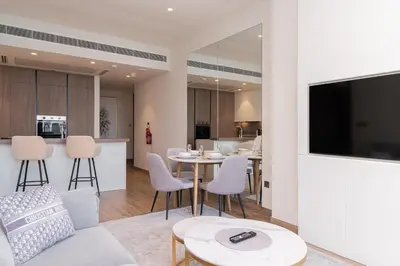 a living room with a couch and a table at Luton Vacation Homes - Luxury & Sea View 1BR - Jumeirah Living Marina Gate Tower 3 - 40AB12 in Dubai