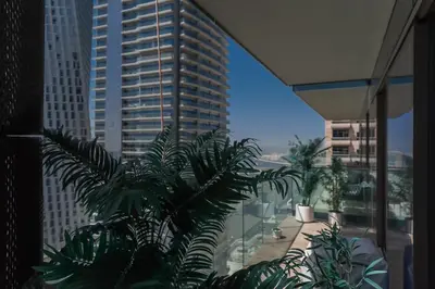 a view of a tall building from a balcony at Luton Vacation Homes - Luxury & Sea View 1BR - Jumeirah Living Marina Gate Tower 3 - 40AB12 in Dubai