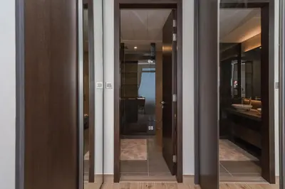 a bathroom with two glass doors and a sink at Luton Vacation Homes - Luxury & Sea View 1BR - Jumeirah Living Marina Gate Tower 3 - 40AB12 in Dubai