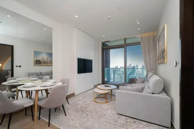 a living room with a couch and a table at Luton Vacation Homes - Luxury & Sea View 1BR - Jumeirah Living Marina Gate Tower 3 - 40AB12 in Dubai