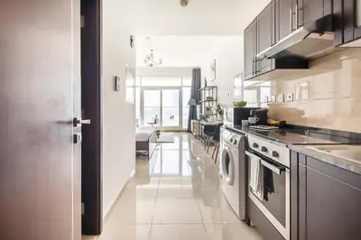 a kitchen with a stove and a washer and dryer at Frank Porter - Siraj Tower in Dubai