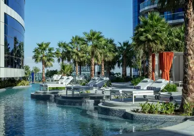 a resort with palm trees and a swimming pool at DAMAC Towers by Paramount Hotels & Resorts Dubai in Dubai
