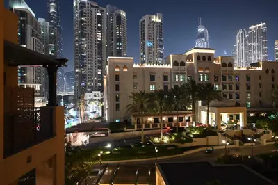 a view of a city at night with tall buildings at Burj Khalifa view, birds chirping, cozy and stylish in Dubai