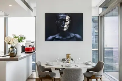a dining room with a bust of a man at 2BR Marina Gate 3 High Floor Marina View in Dubai