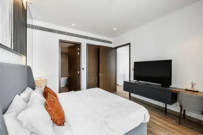 a bedroom with a bed and a flat screen tv at 2BR Marina Gate 3 High Floor Marina View in Dubai