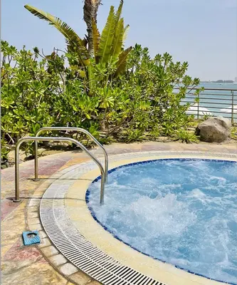 a swimming pool with a faucet in front at Tiara Residence - Palm Jumeirah Dubai in Dubai
