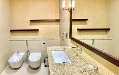 a bathroom with a sink and a toilet and a mirror at Tiara Residence - Palm Jumeirah Dubai in Dubai