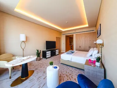 a hotel room with a bed and a table and chairs at ORION in Dubai