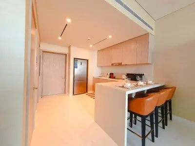a kitchen with a counter and some chairs in it at ORION in Dubai