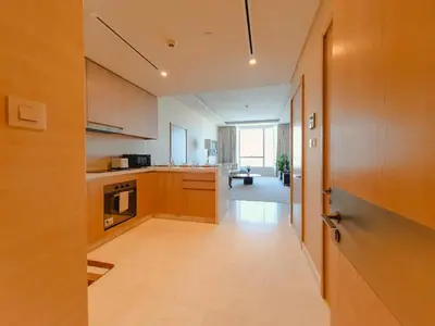 a large kitchen with wooden cabinets and a hallway at ORION in Dubai