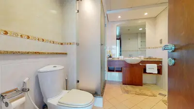 a bathroom with a toilet and a sink at LV38 - Elegant 2BHK in Lake View Tower in Dubai