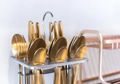 a group of gold spoons on a metal rack at Palm Tower Palm Jumeirah Dubai in Dubai