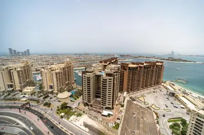 an aerial view of a city with buildings and the ocean at Palm Tower Palm Jumeirah Dubai in Dubai