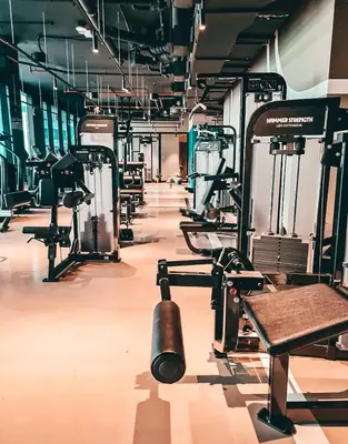 a gym with rows of treadmills and weights at Elite Royal Apartment - Panoramic Burj Khalifa, Fountain & Dubai skyline view - Marquise in Dubai