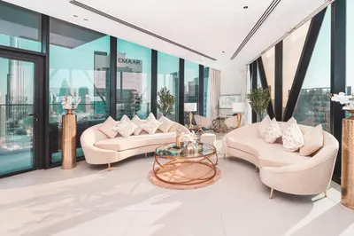 a living room with two couches and a glass table at Elite Royal Apartment - Panoramic Burj Khalifa, Fountain & Dubai skyline view - Marquise in Dubai
