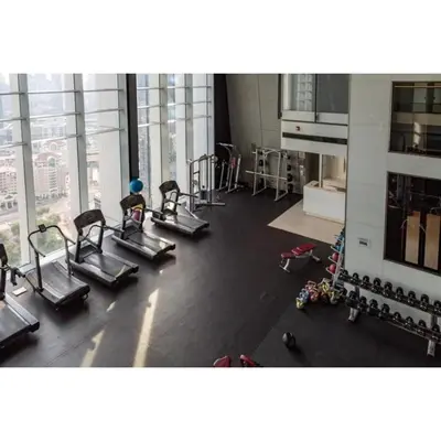 a gym with several treadmills and machines at Silkhaus contemporary 1BDR with Downtown view in DIFC in Dubai