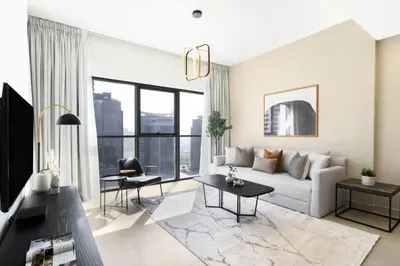a living room with a couch and a table at Silkhaus unique 1BDR pad gorgeous view in new tower in Dubai