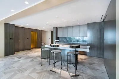 a kitchen with a counter and bar stools at FIVE Palm Beachfront Villa -Private Pool & Jacuzzi, Panoramic Views, by Exclusive Holiday Homes in Dubai