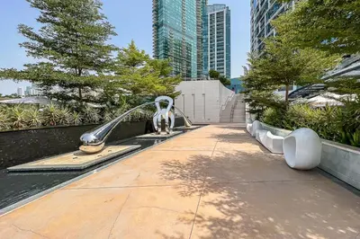 a fountain in a park with buildings in the background at Frank Porter - The Address JBR in Dubai