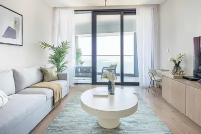 a living room with a couch and a coffee table at Frank Porter - The Address JBR in Dubai