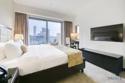 a bedroom with a large bed and a large window at Steps Away From Marina Mall with Iconic Marina Canal Views, The Address Residences, Dubai Marina by Deluxe Holiday Homes in Dubai