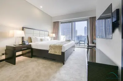 a hotel room with a bed and a large window at Steps Away From Marina Mall with Iconic Marina Canal Views, The Address Residences, Dubai Marina by Deluxe Holiday Homes in Dubai