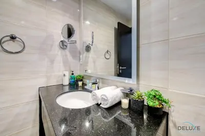 a bathroom with a sink and a mirror at Superb Studio at Damac Celestia A Dubai South By Deluxe Holiday Homes in Dubai