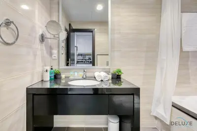 a bathroom with a sink and a mirror at Superb Studio at Damac Celestia A Dubai South By Deluxe Holiday Homes in Dubai