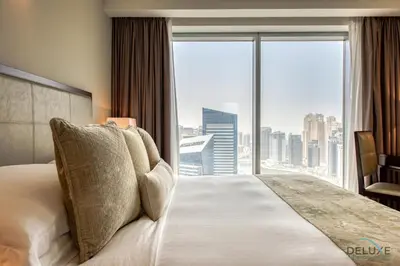a bedroom with a large bed with a large window at Marina Gem with Overlooking Canal Views 1BR Next to Mall, The Address Residences, Dubai Marina by Deluxe Holiday Homes in Dubai