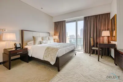 a large hotel room with a bed and a desk at Pristine 3BR at The Address Residences Dubai Marina by Deluxe Holiday Homes in Dubai