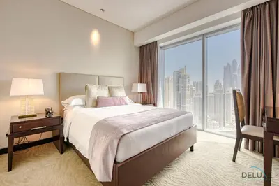 a bedroom with a bed and a desk and a large window at Pristine 3BR at The Address Residences Dubai Marina by Deluxe Holiday Homes in Dubai