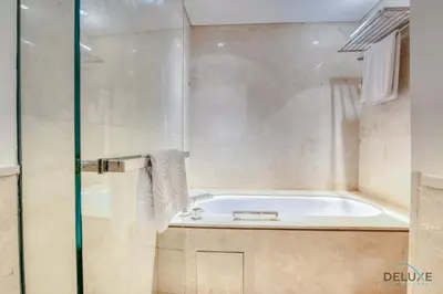 a bathroom with a bath tub and a shower at Pristine 3BR at The Address Residences Dubai Marina by Deluxe Holiday Homes in Dubai