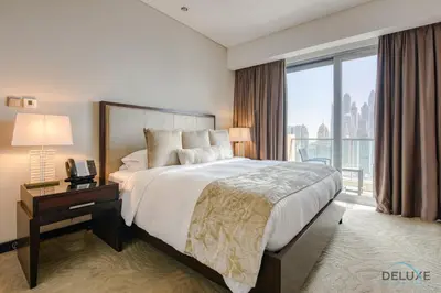a bedroom with a large bed and a large window at Pristine 3BR at The Address Residences Dubai Marina by Deluxe Holiday Homes in Dubai