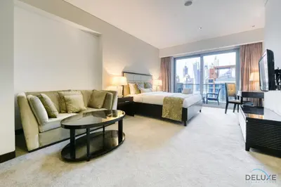 a hotel room with a bed and a couch at Regal Studio at The Address Residences Dubai Marina by Deluxe Holiday Homes in Dubai