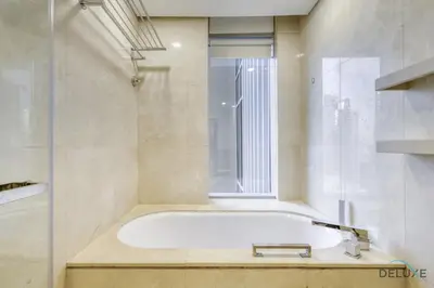 a bath tub in a bathroom with a window at Regal Studio at The Address Residences Dubai Marina by Deluxe Holiday Homes in Dubai