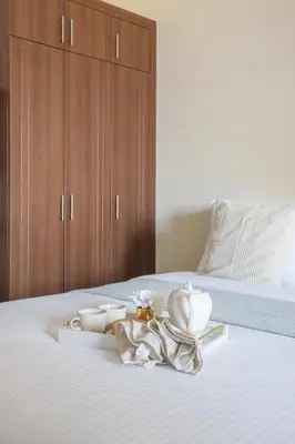 a bed with a tray with bowls and dishes on it at Frank Porter - Elite Sports Residence in Dubai