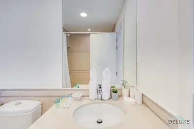 a bathroom with a sink and a toilet at Fancy 2BR at Hayat Boulevard 2A Town Square By Deluxe Holiday Home in Dubai