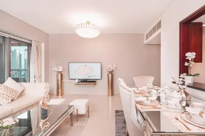 a dining room with a table and a couch at Elite Royal Apartment - Highest Floor - Full Burj Khalifa & Fountain View - Duke in Dubai