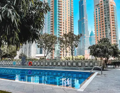 a swimming pool in a city with tall buildings at Elite Royal Apartment - Highest Floor - Full Burj Khalifa & Fountain View - Duke in Dubai