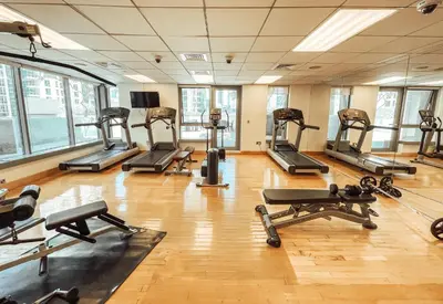 a gym with several treadmills and exercise machines at Elite Royal Apartment - Highest Floor - Full Burj Khalifa & Fountain View - Duke in Dubai