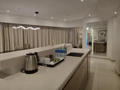a kitchen with a counter with a sink and a counter sidx sidx sidx at Quill Residence at Paramount Towers 3 BR Creek View in Dubai