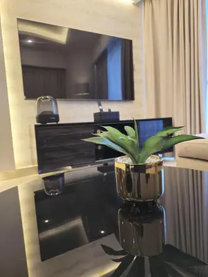 a room with a table with a plant on it at Quill Residence at Paramount Towers 3 BR Creek View in Dubai